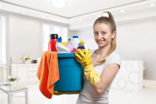 Staff member using protective gloves during oven cleaning